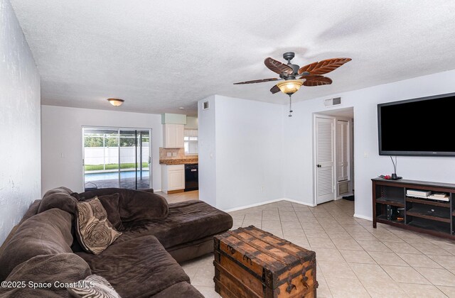 1661 Sandusky St SE, Palm Bay, FL 32909 - living area featuring a ceiling fan, light tile patterned floors, and a textured ceiling
