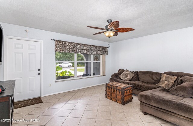 1661 Sandusky St SE, Palm Bay, FL 32909 - living room featuring ceiling fan, a textured ceiling, and light tile patterned flooring