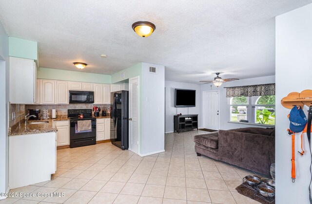 1661 Sandusky St SE, Palm Bay, FL 32909 - kitchen with black appliances, open floor plan, decorative backsplash, light tile patterned flooring, and a ceiling fan