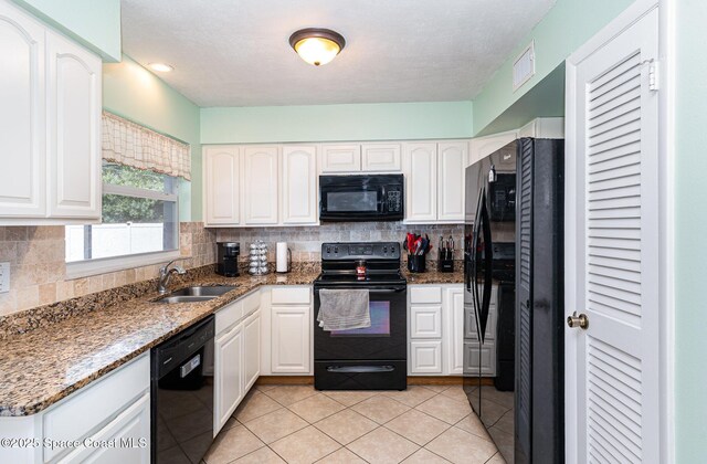 1661 Sandusky St SE, Palm Bay, FL 32909 - kitchen featuring black appliances, white cabinetry, and stone counters