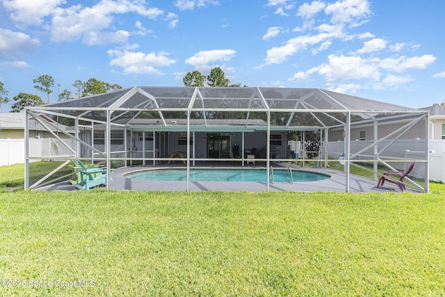 1661 Sandusky St SE, Palm Bay, FL 32909 - back of house with a fenced backyard, glass enclosure, and a patio area