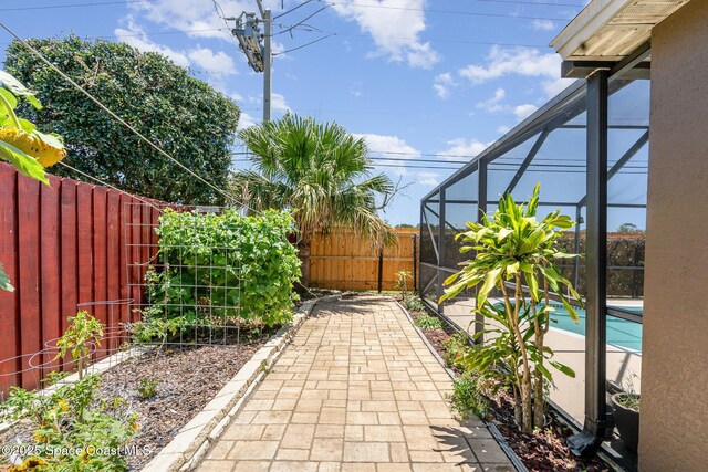 713 Del Mar Cir, Melbourne, FL 32904 - fenced backyard featuring a patio and glass enclosure