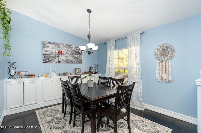 713 Del Mar Cir, Melbourne, FL 32904 - dining space featuring a chandelier, vaulted ceiling, and dark wood finished floors