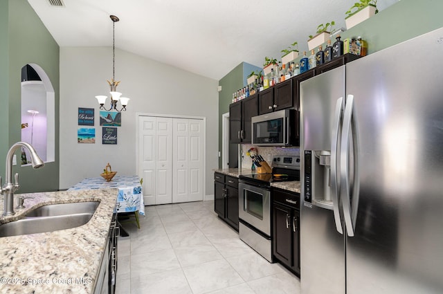 713 Del Mar Cir, Melbourne, FL 32904 - kitchen with stainless steel appliances, a chandelier, pendant lighting, high vaulted ceiling, and light stone countertops