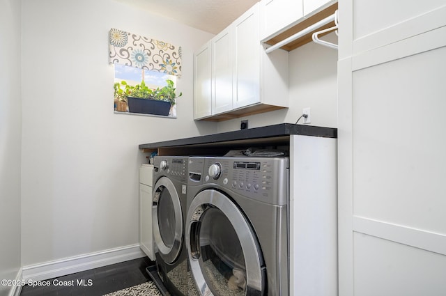 713 Del Mar Cir, Melbourne, FL 32904 - washroom with washer and dryer, cabinet space, and dark wood-type flooring