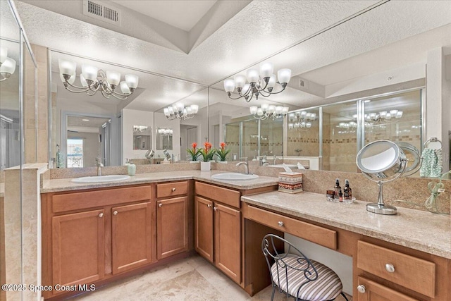 121 Lancha Cir Unit 203, Indian Harbour Beach, FL 32937 - bathroom with a chandelier, double vanity, and a stall shower