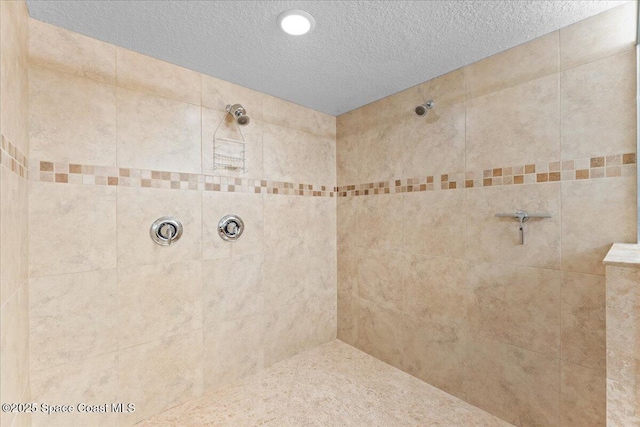 121 Lancha Cir Unit 203, Indian Harbour Beach, FL 32937 - bathroom featuring a tile shower and a textured ceiling
