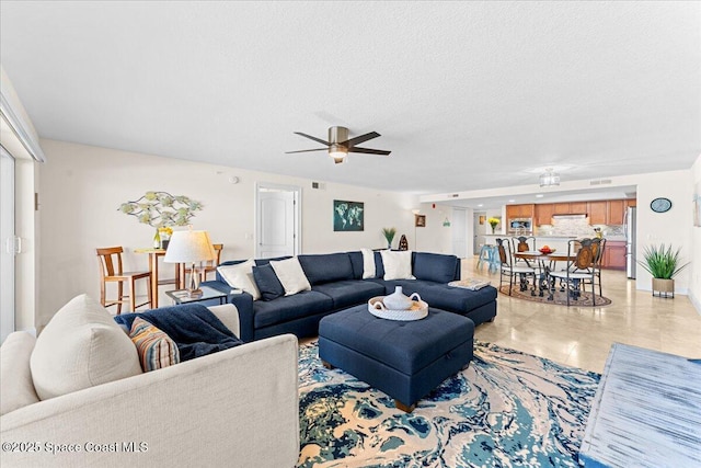 121 Lancha Cir Unit 203, Indian Harbour Beach, FL 32937 - living room featuring a ceiling fan and a textured ceiling