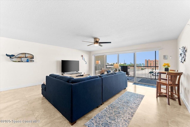 121 Lancha Cir Unit 203, Indian Harbour Beach, FL 32937 - living room with a textured ceiling and a ceiling fan