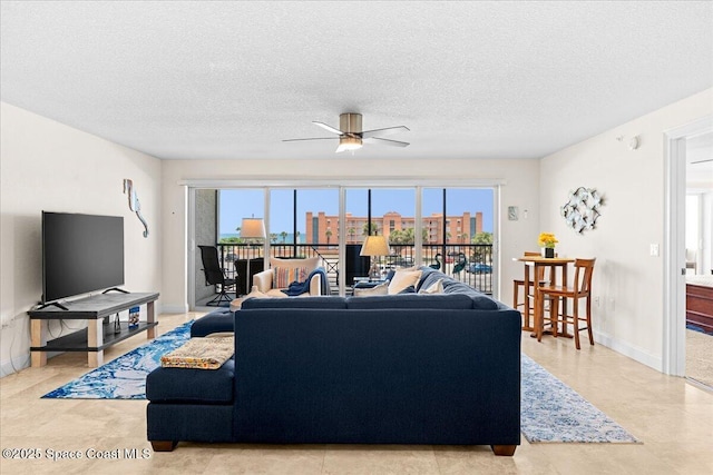 121 Lancha Cir Unit 203, Indian Harbour Beach, FL 32937 - living area with plenty of natural light, ceiling fan, and a textured ceiling