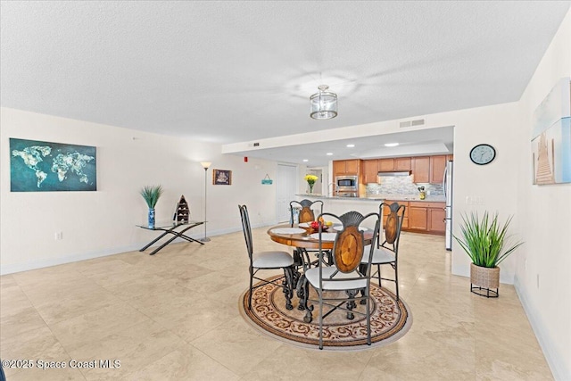121 Lancha Cir Unit 203, Indian Harbour Beach, FL 32937 - dining area with a textured ceiling