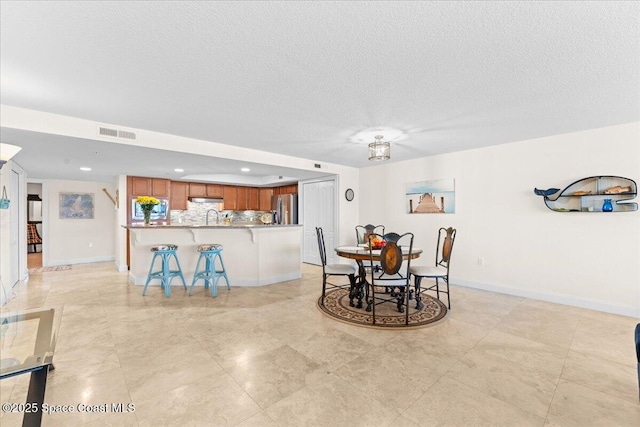 121 Lancha Cir Unit 203, Indian Harbour Beach, FL 32937 - dining room featuring a textured ceiling and recessed lighting