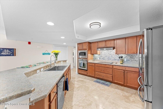 121 Lancha Cir Unit 203, Indian Harbour Beach, FL 32937 - kitchen with appliances with stainless steel finishes, brown cabinets, under cabinet range hood, tasteful backsplash, and a raised ceiling