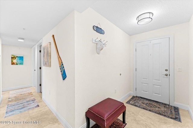 121 Lancha Cir Unit 203, Indian Harbour Beach, FL 32937 - entrance foyer featuring baseboards and light tile patterned floors