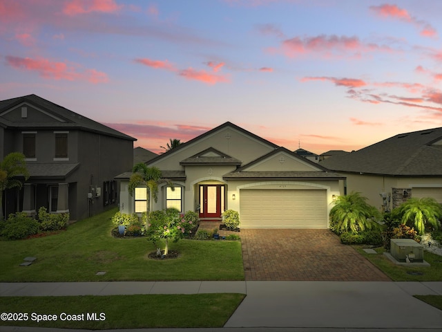 4729 Alligator Flag Cir, West Melbourne, FL 32904 - single story home featuring decorative driveway, a garage, stucco siding, and a lawn