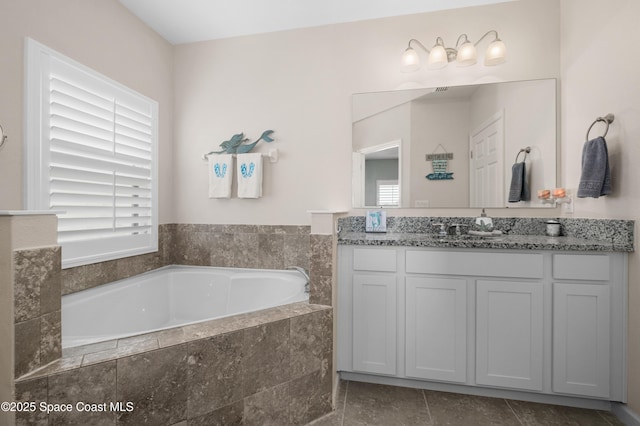 4729 Alligator Flag Cir, West Melbourne, FL 32904 - full bathroom with healthy amount of natural light, a bath, vanity, and tile patterned flooring