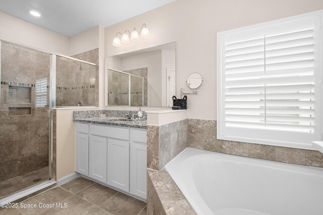 4729 Alligator Flag Cir, West Melbourne, FL 32904 - bathroom featuring a bath, a shower stall, vanity, and tile patterned floors