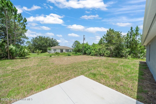 1011 Webster Rd SE, Palm Bay, FL 32909 - view of grassy yard with a patio area