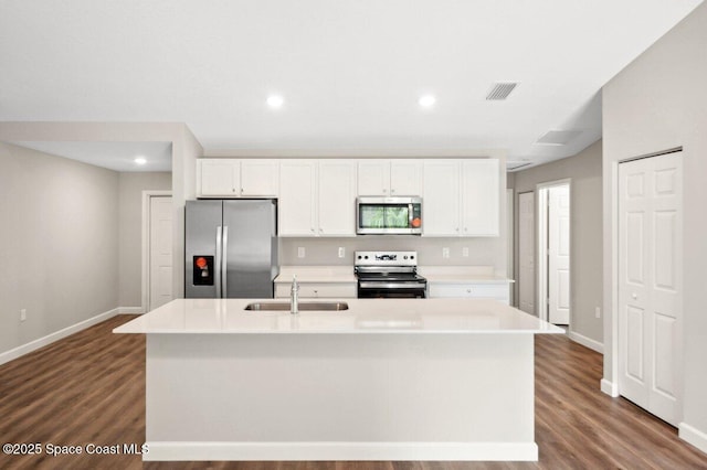 1011 Webster Rd SE, Palm Bay, FL 32909 - kitchen with appliances with stainless steel finishes, white cabinetry, dark wood-style flooring, light countertops, and recessed lighting
