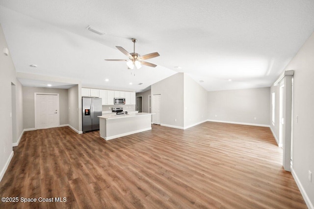 1011 Webster Rd SE, Palm Bay, FL 32909 - unfurnished living room with lofted ceiling, wood finished floors, ceiling fan, and recessed lighting