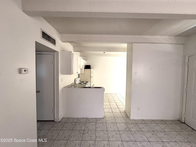 1715 Dixon Blvd Unit 102, Cocoa, FL 32922 - kitchen with beam ceiling, white cabinetry, and white appliances