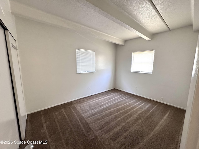 1715 Dixon Blvd Unit 102, Cocoa, FL 32922 - spare room featuring dark carpet, a textured ceiling, and beamed ceiling