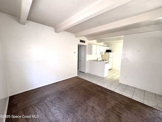1715 Dixon Blvd Unit 102, Cocoa, FL 32922 - unfurnished living room with beamed ceiling, light tile patterned flooring, and light colored carpet
