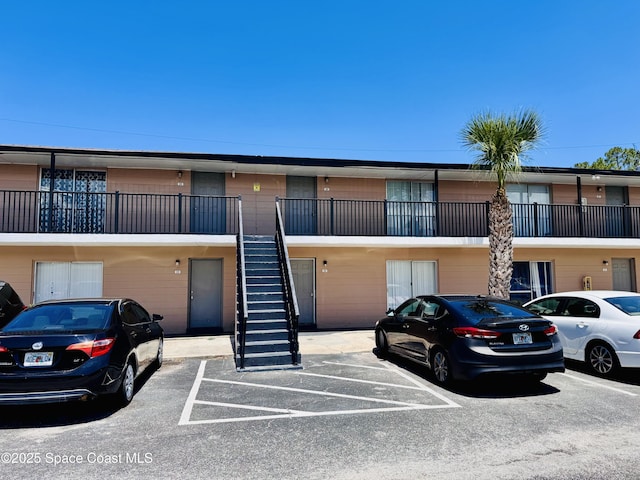 1721 Dixon Blvd Unit 36, Cocoa, FL 32922 - view of building exterior with stairway and uncovered parking