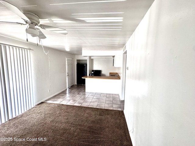 1721 Dixon Blvd Unit 36, Cocoa, FL 32922 - unfurnished living room featuring ceiling fan, carpet floors, and tile patterned flooring
