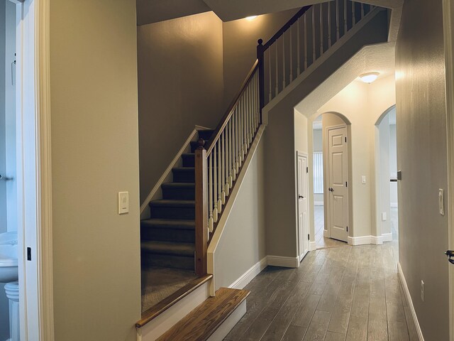 117 Anchorage Ave Unit 6, Cape Canaveral, FL 32920 - stairs featuring arched walkways and hardwood / wood-style floors