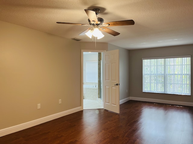 117 Anchorage Ave Unit 6, Cape Canaveral, FL 32920 - empty room featuring dark wood finished floors, ceiling fan, and a textured ceiling