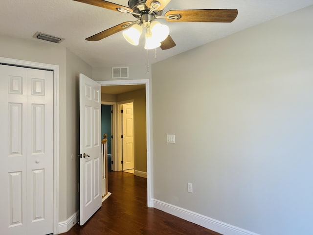 117 Anchorage Ave Unit 6, Cape Canaveral, FL 32920 - unfurnished bedroom featuring a closet, dark wood-type flooring, and ceiling fan