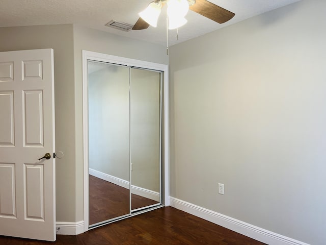 117 Anchorage Ave Unit 6, Cape Canaveral, FL 32920 - unfurnished bedroom with a closet, wood finished floors, and a ceiling fan