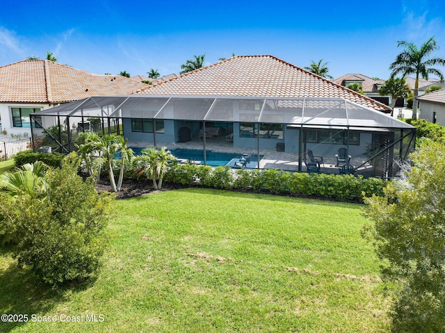 5197 Kirkwall Cir, Melbourne, FL 32940 - back of property featuring a tiled roof, a patio area, a yard, and glass enclosure