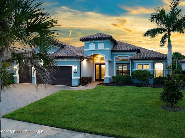 5197 Kirkwall Cir, Melbourne, FL 32940 - mediterranean / spanish-style house featuring french doors, a tile roof, and a front yard