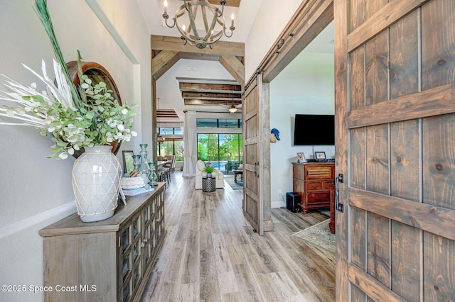 5197 Kirkwall Cir, Melbourne, FL 32940 - foyer entrance with light wood-style flooring, a chandelier, and beam ceiling