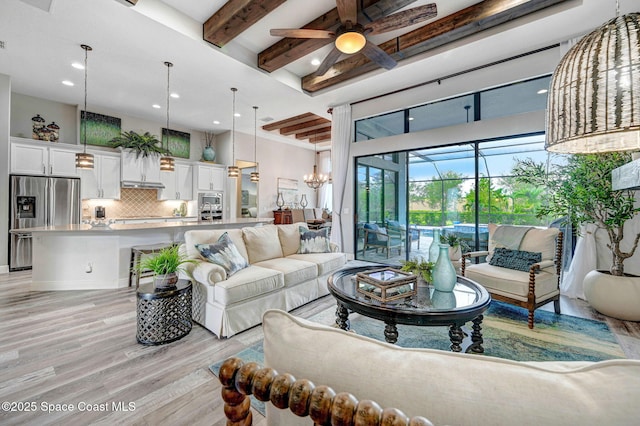 5197 Kirkwall Cir, Melbourne, FL 32940 - living area with a ceiling fan, light wood-style floors, beam ceiling, recessed lighting, and a towering ceiling