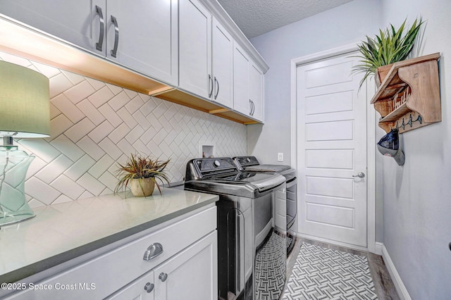 5197 Kirkwall Cir, Melbourne, FL 32940 - washroom featuring washing machine and clothes dryer, cabinet space, and a textured ceiling