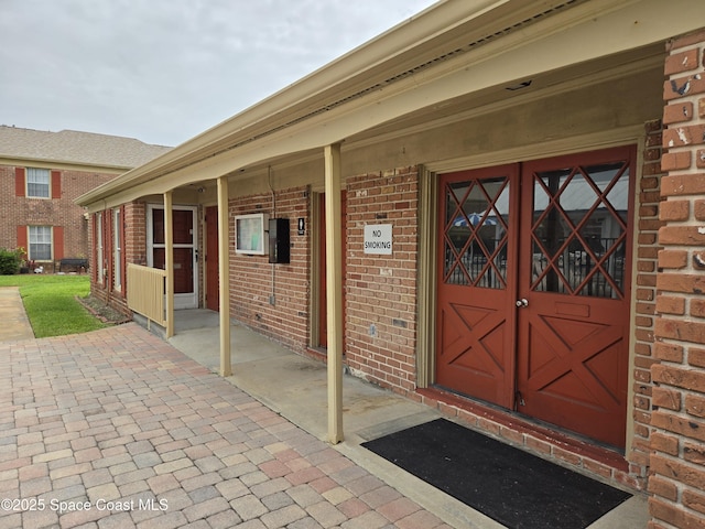 152 E Colonial Ct Unit 84, Indian Harbour Beach, FL 32937 - property entrance featuring brick siding and a porch