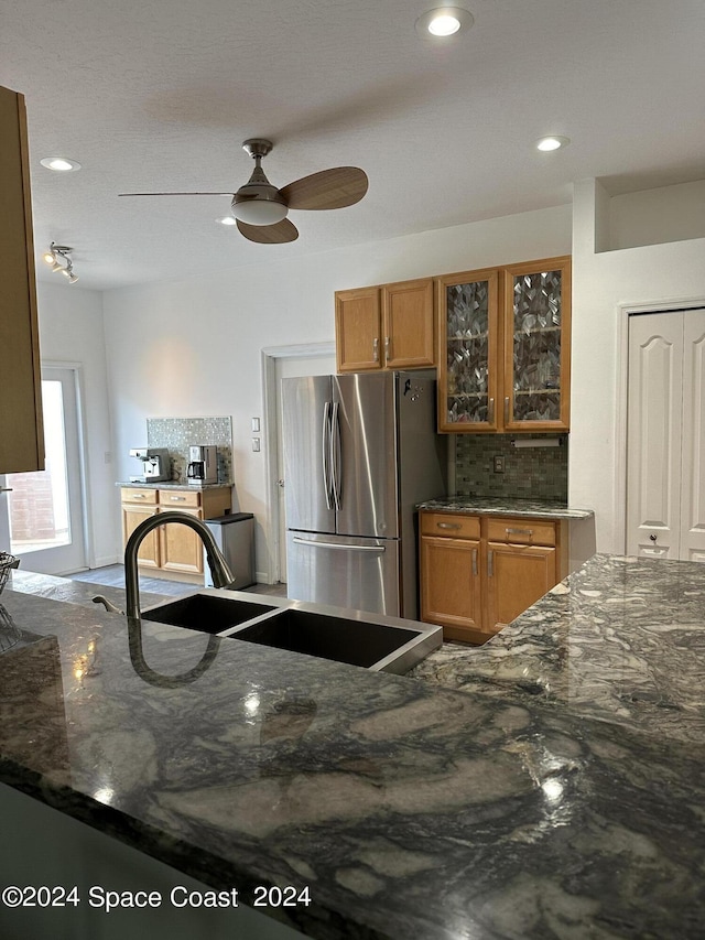 184 Calico Ln, Indialantic, FL 32903 - kitchen featuring freestanding refrigerator, brown cabinets, glass insert cabinets, dark stone countertops, and recessed lighting