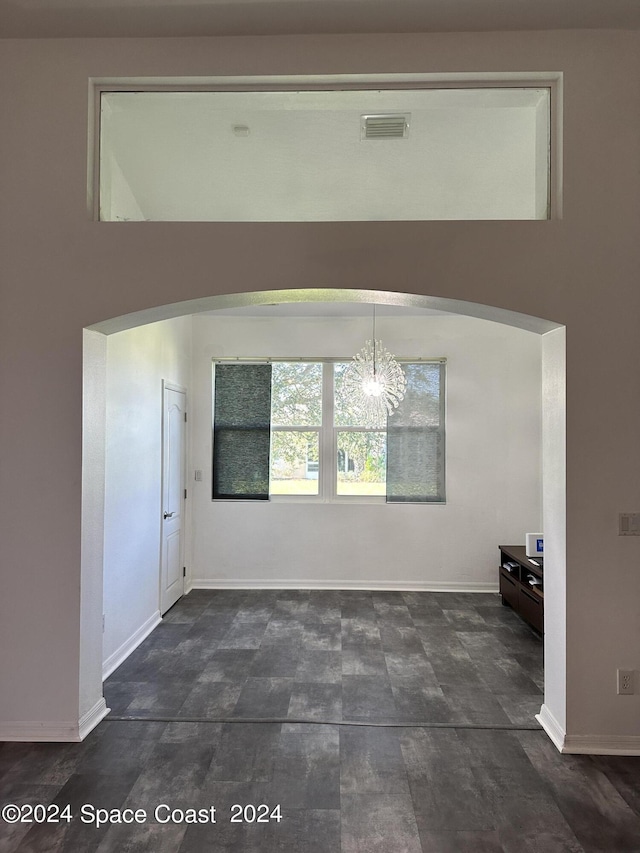 184 Calico Ln, Indialantic, FL 32903 - entrance foyer featuring arched walkways and a chandelier