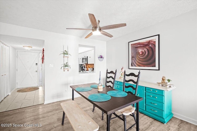 1611 Minutemen Cswy Unit 107-Hh, Cocoa Beach, FL 32931 - dining space featuring light wood-type flooring, ceiling fan, and a textured ceiling