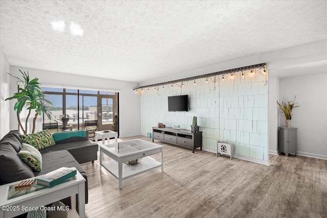 1611 Minutemen Cswy Unit 107-Hh, Cocoa Beach, FL 32931 - living area featuring a textured ceiling and wood finished floors