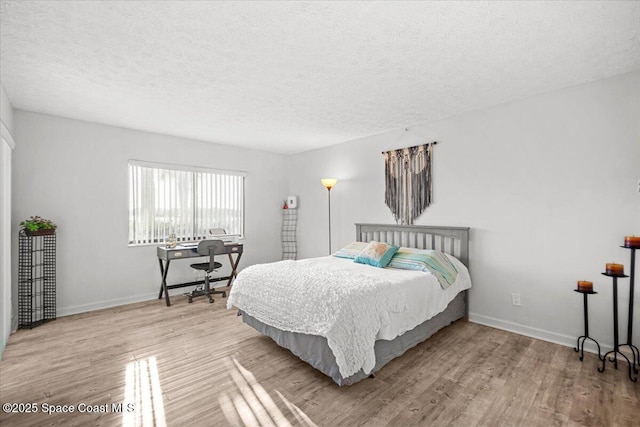 1611 Minutemen Cswy Unit 107-Hh, Cocoa Beach, FL 32931 - bedroom featuring a textured ceiling and wood finished floors