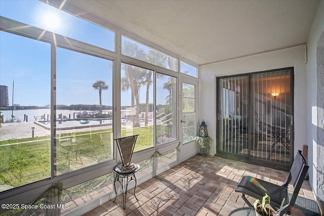 1611 Minutemen Cswy Unit 107-Hh, Cocoa Beach, FL 32931 - sunroom / solarium with a water view and brick patterned flooring