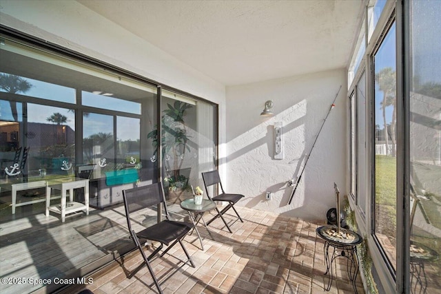 1611 Minutemen Cswy Unit 107-Hh, Cocoa Beach, FL 32931 - sunroom with plenty of natural light and a textured wall