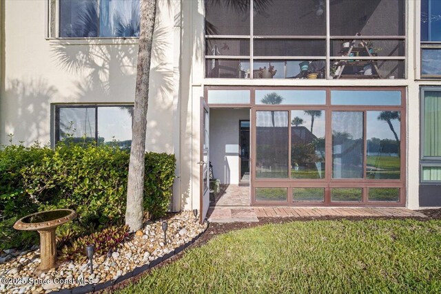 1611 Minutemen Cswy Unit 107-Hh, Cocoa Beach, FL 32931 - doorway to property with stucco siding