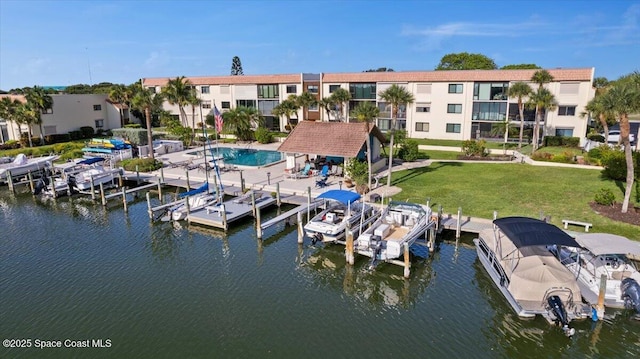 1611 Minutemen Cswy Unit 107-Hh, Cocoa Beach, FL 32931 - dock with boat lift, a yard, and a water view