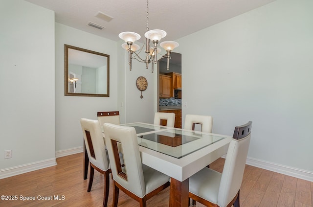 2351 Stonebridge Dr, Rockledge, FL 32955 - dining room featuring a chandelier and light wood-style flooring