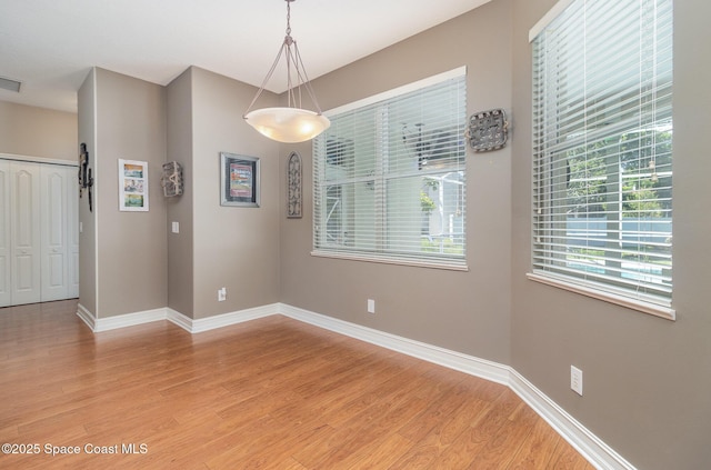 2351 Stonebridge Dr, Rockledge, FL 32955 - unfurnished dining area with light wood-type flooring and baseboards